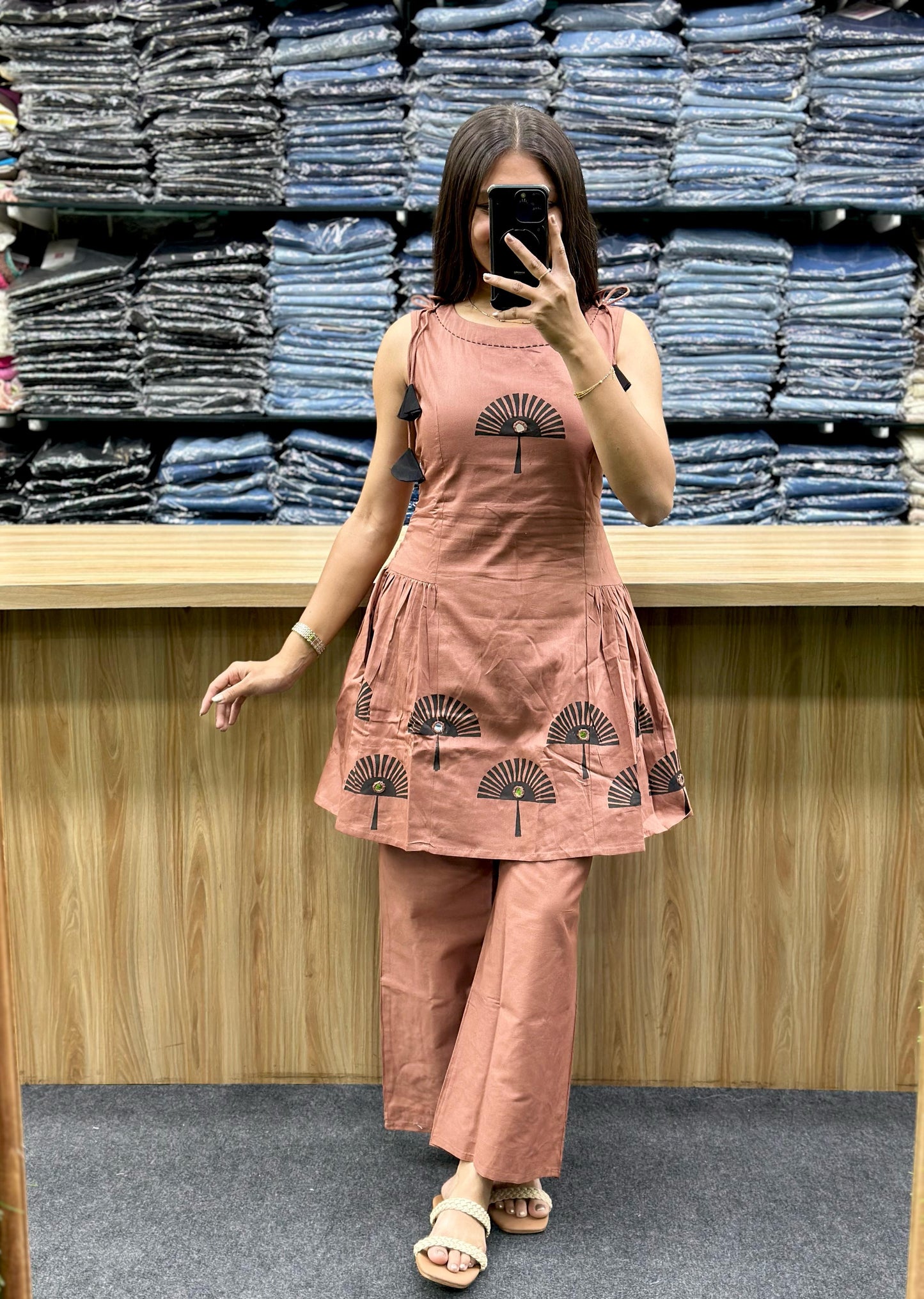 Woman wearing the latest designer co-ord set in brown with fan print and matching pants