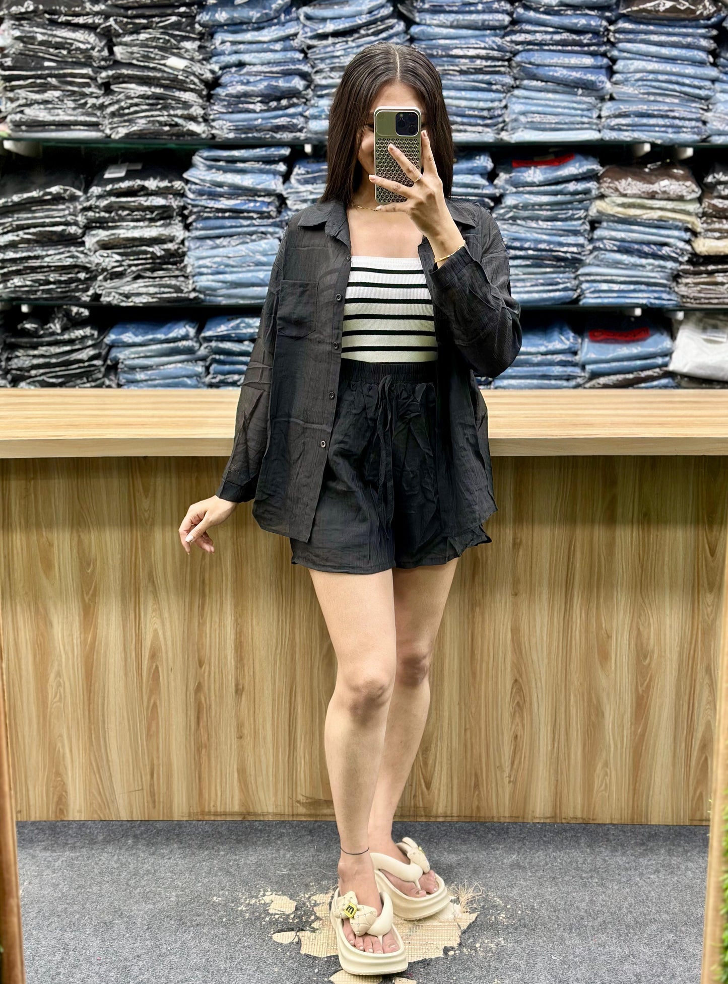 Woman wearing black summer casual cotton outfits with striped top and shorts in a clothing store