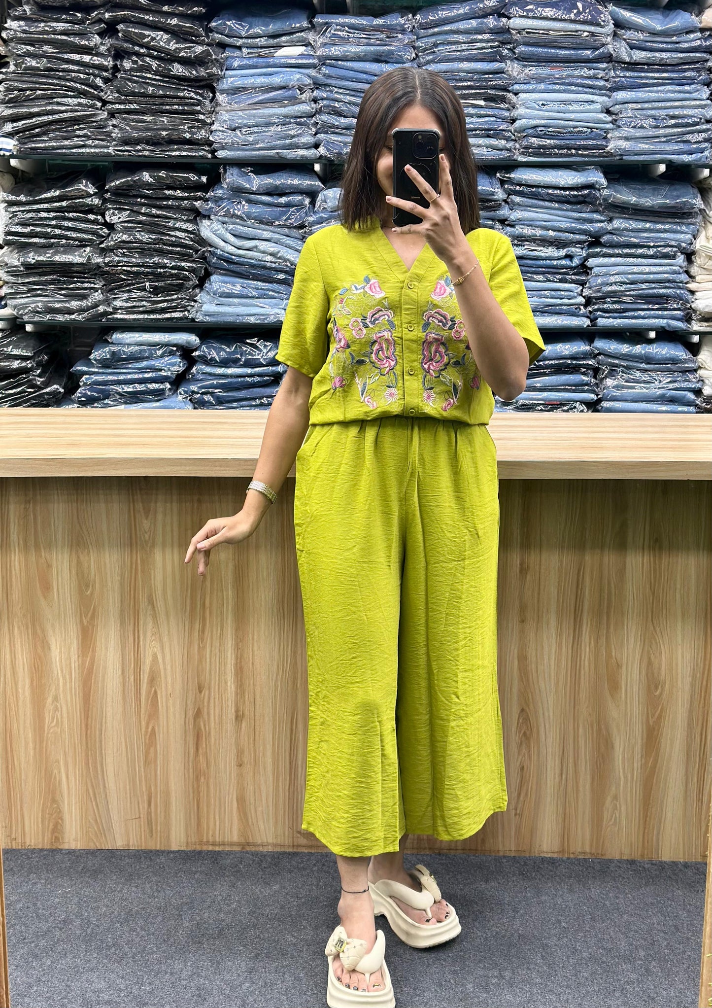 Woman wearing lime green embroidered short sleeve top and matching wide-leg pants outfit by Vinayak Fashion