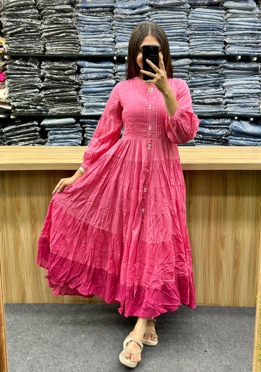 Woman wearing a pink ethnic cotton frock online in a store with folded denim jeans in the background