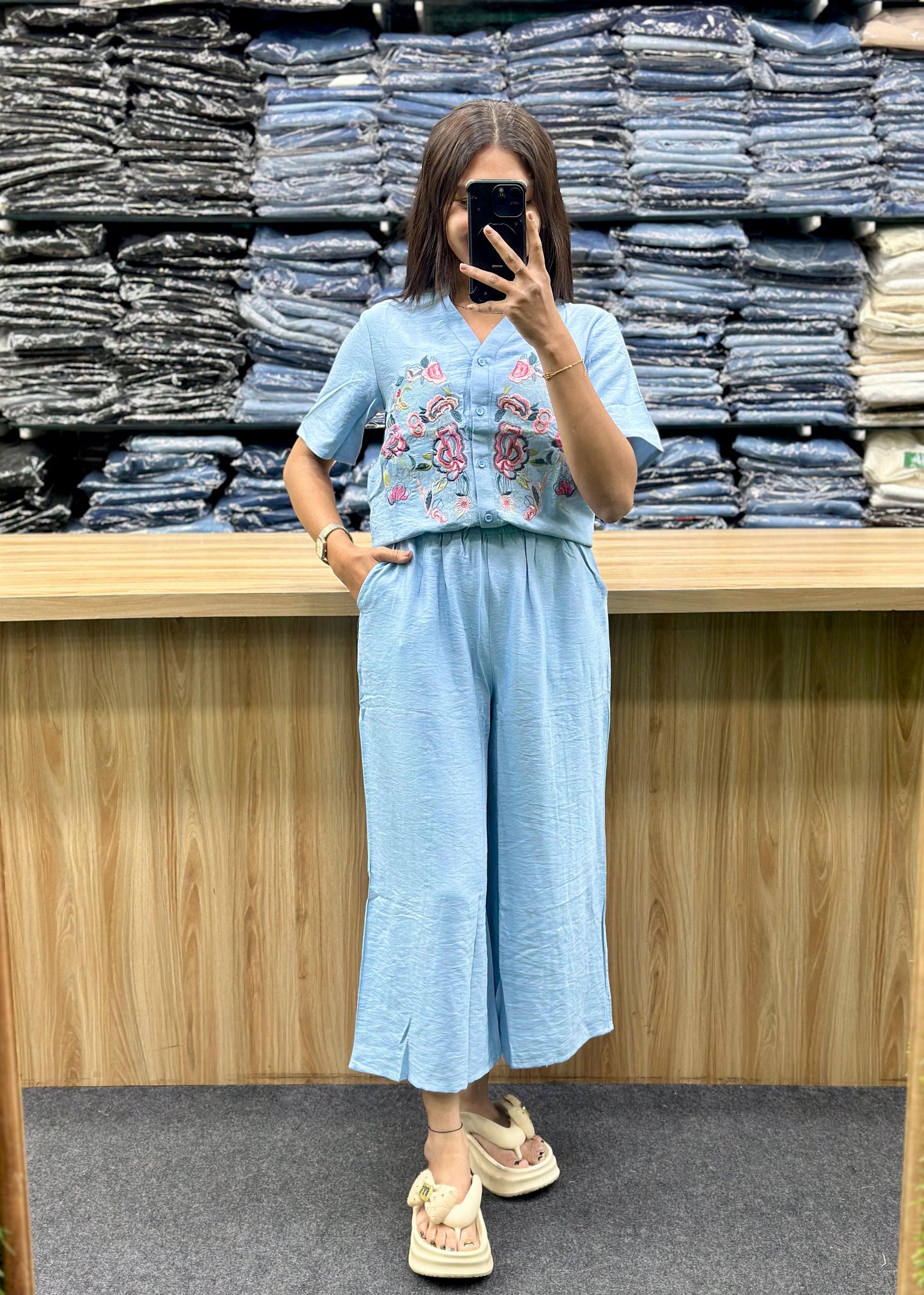 Woman wearing light blue embroidered top and matching wide-leg pants from Vinayak Fashion