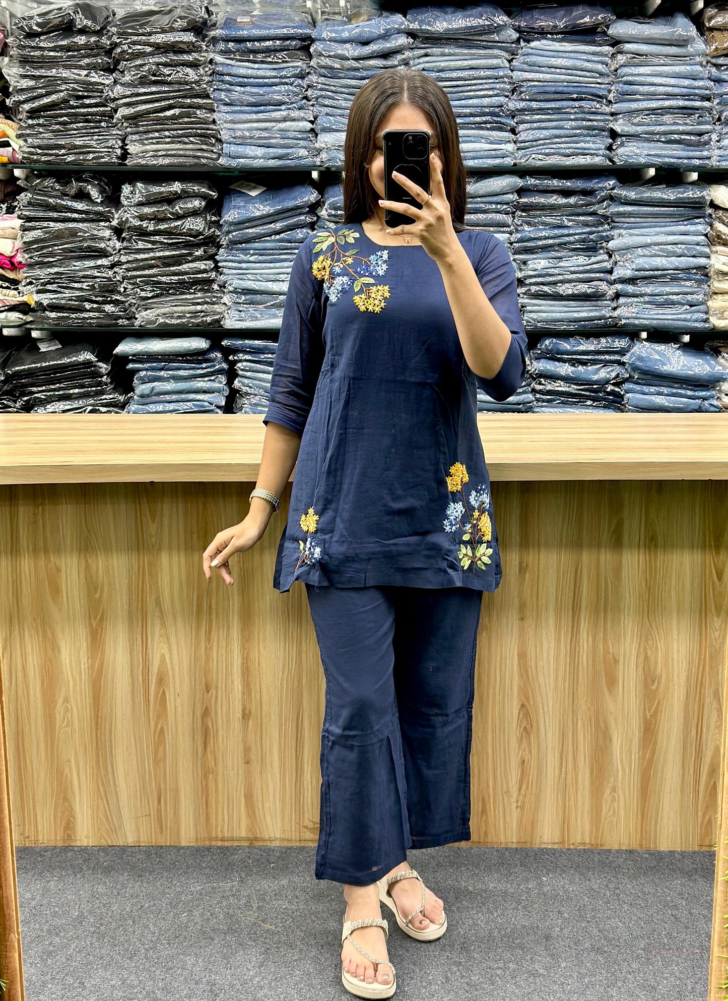Vinayak Fashion navy blue floral cotton co ord set modeled by woman against stacked denim background