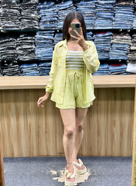 Woman wearing light yellow summer casual cotton outfits with shorts and a shirt in a clothing store